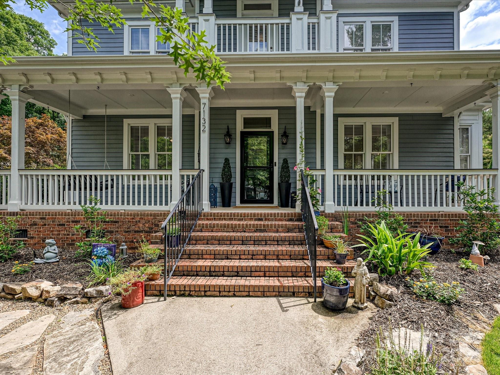7132 Michael Scott Crossing Fort Mill, SC 29708 - Photo 3 of 41 a view of a house with a small yard and flower plants