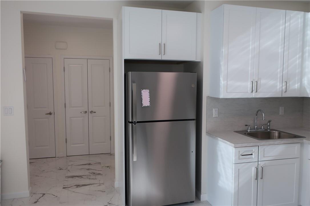 4203 Corner Spring Valley, NY 10977 - Photo 5 of 18 a white refrigerator freezer sitting in a kitchen
