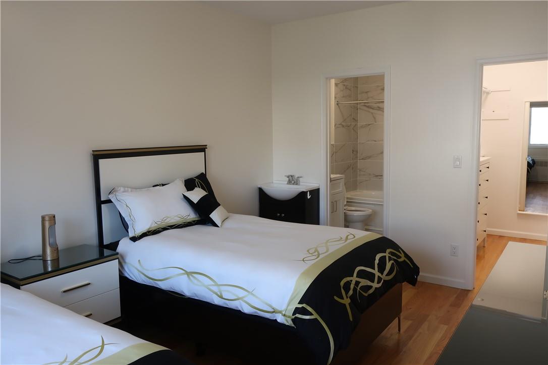 4203 Corner Spring Valley, NY 10977 - Photo 7 of 18 a bedroom with a bed and wooden floor