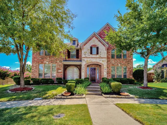 a front view of a house with a yard and porch