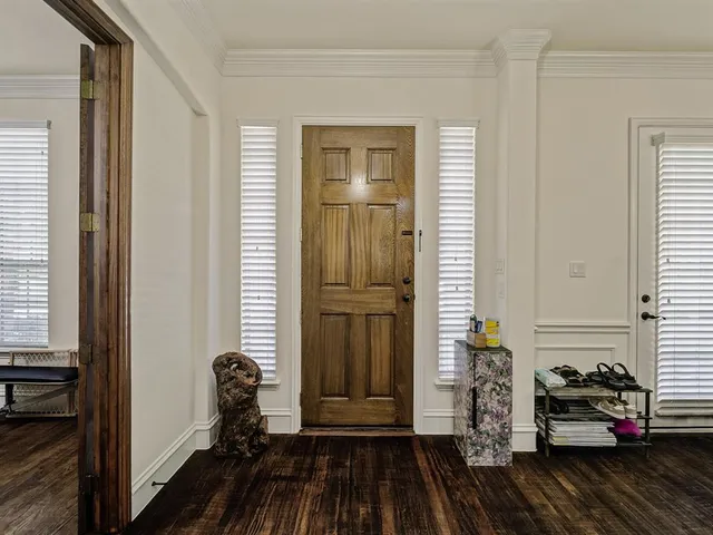 a view of a livingroom with wooden floor and a window