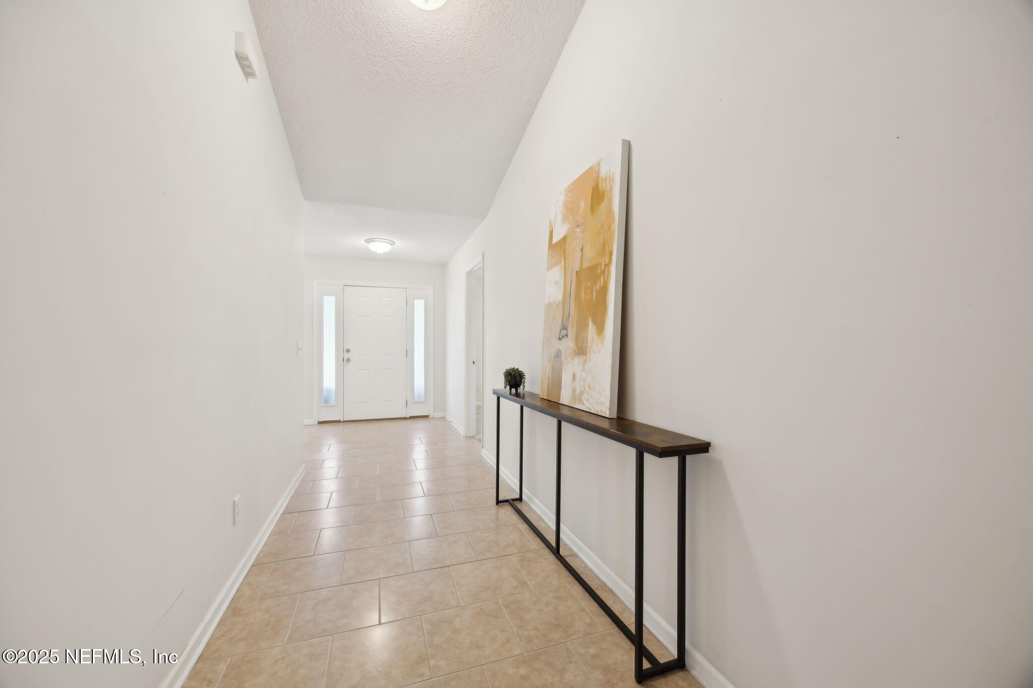 36 Currant Avenue Middleburg, FL 32068 - Photo 11 of 59 a view of a hallway with wooden floor and staircase