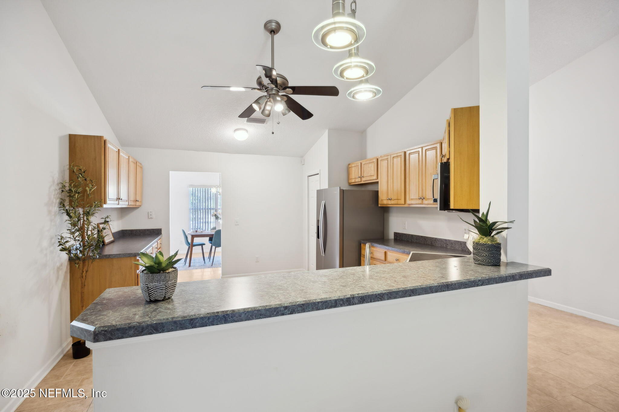 36 Currant Avenue Middleburg, FL 32068 - Photo 16 of 59 a bathroom with a granite countertop sink a potted plant and a mirror