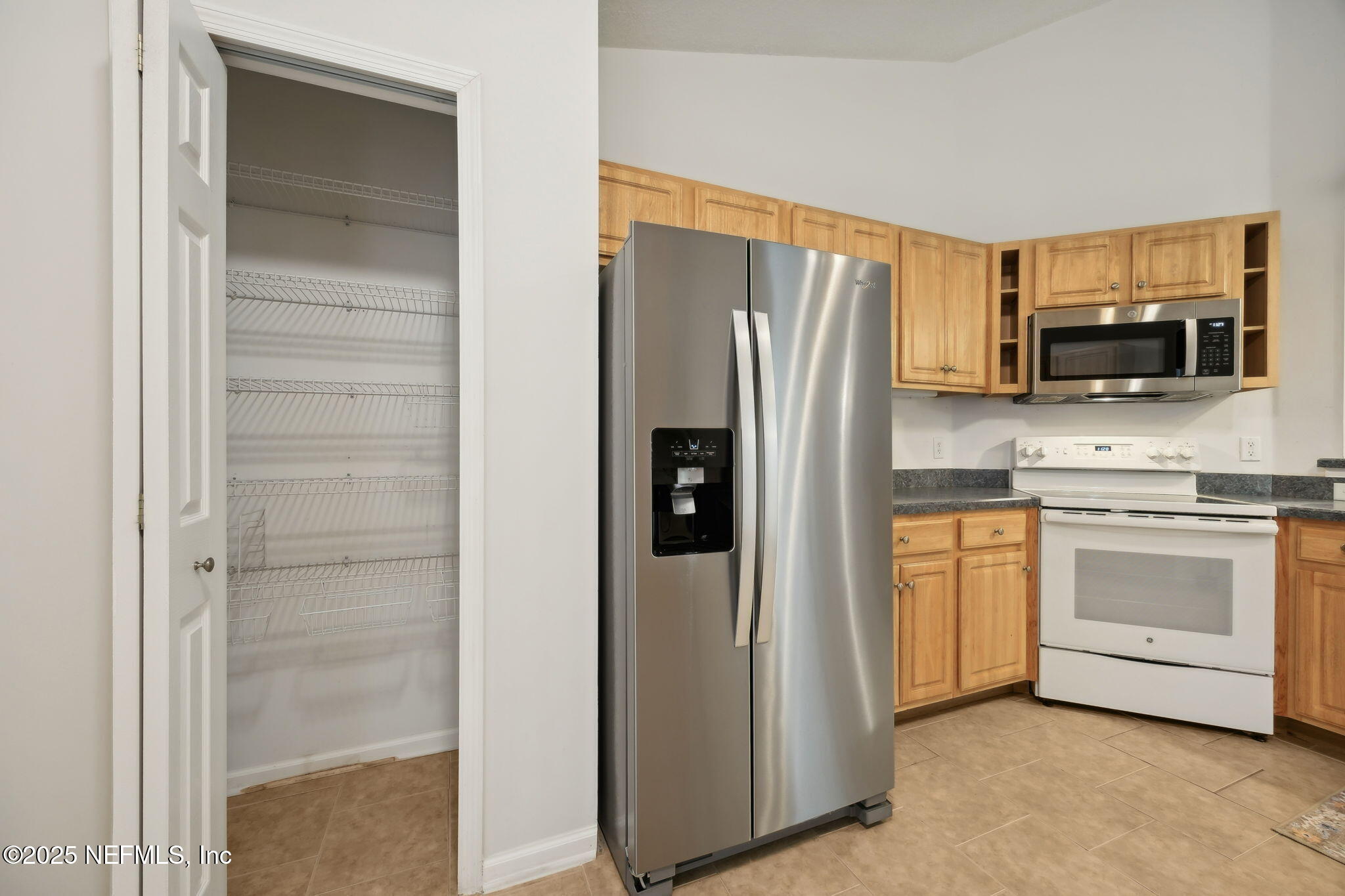 36 Currant Avenue Middleburg, FL 32068 - Photo 20 of 59 a kitchen with stainless steel appliances a refrigerator stove and microwave