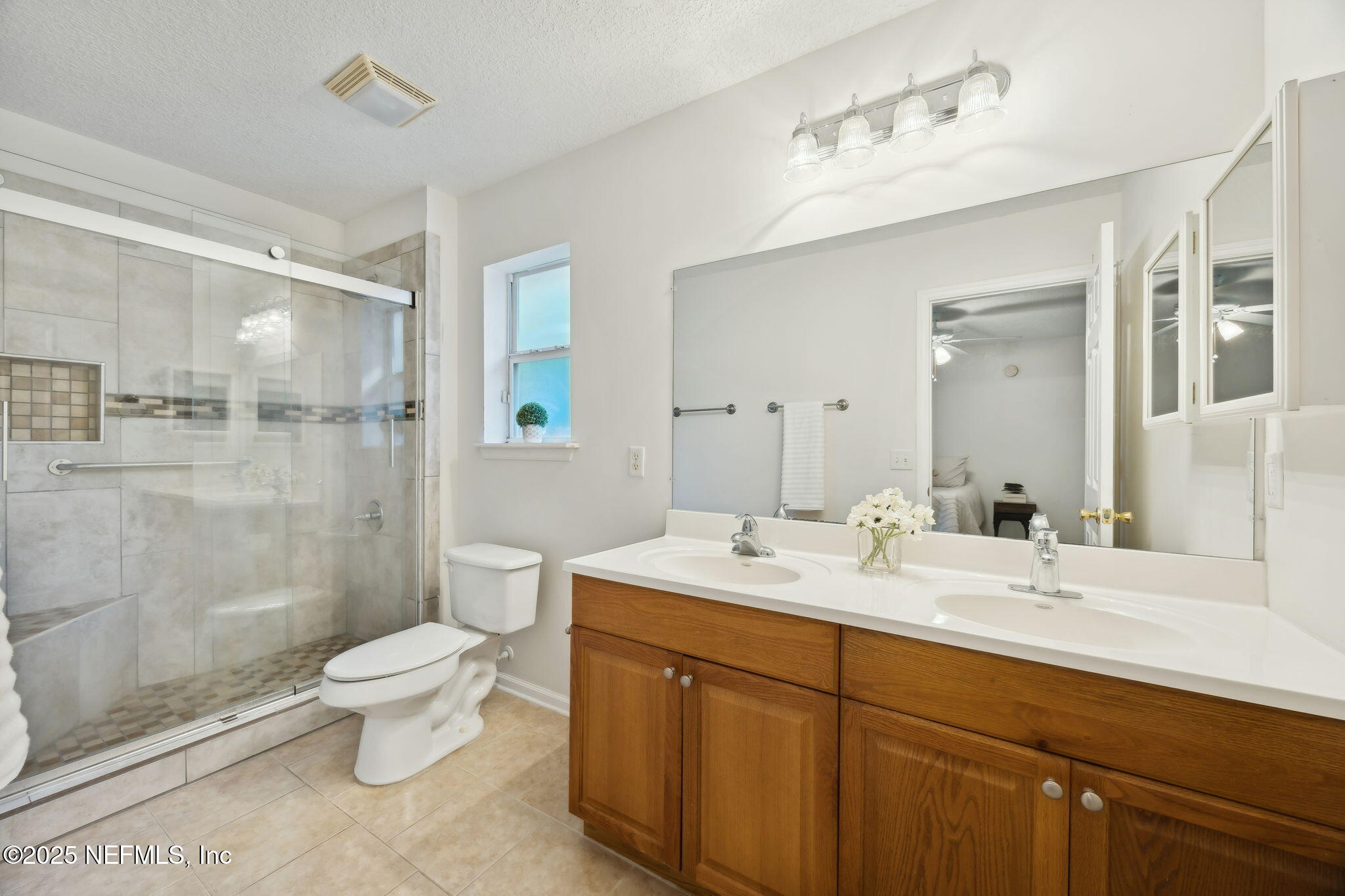 36 Currant Avenue Middleburg, FL 32068 - Photo 29 of 59 a bathroom with a double vanity sink toilet mirror and shower