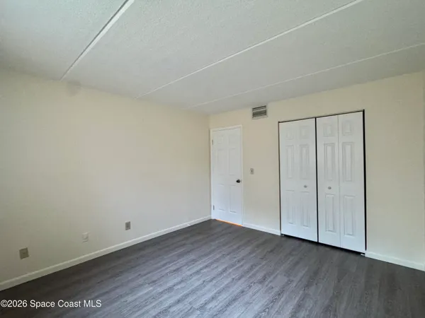 a view of an empty room and wooden floor