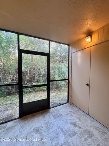 an empty room with large windows