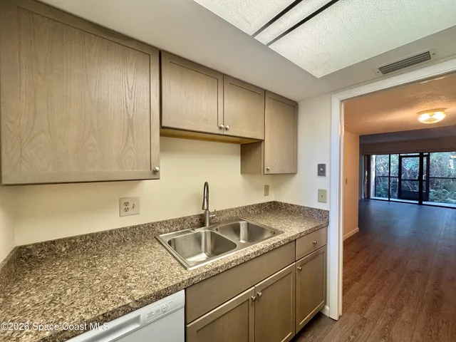 a kitchen that has a sink and a stove