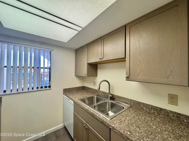 a kitchen with stainless steel appliances granite countertop a sink and a granite counter tops