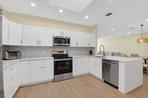 a kitchen with a refrigerator and a sink
