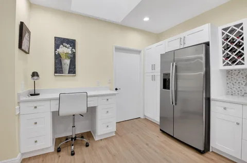a kitchen with a sink cabinets and wooden floor