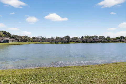 a view of a lake with houses in the back