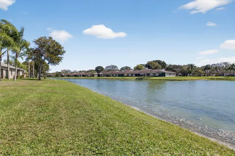 an aerial view of a houses with a lake view
