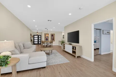 a view of an entryway with wooden floor and a gate