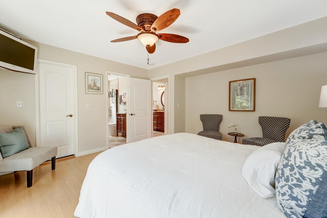 637 Laird Lane Lafayette, CA 94549 - Photo 26 of 44 a spacious bedroom with a bed and a chandelier
