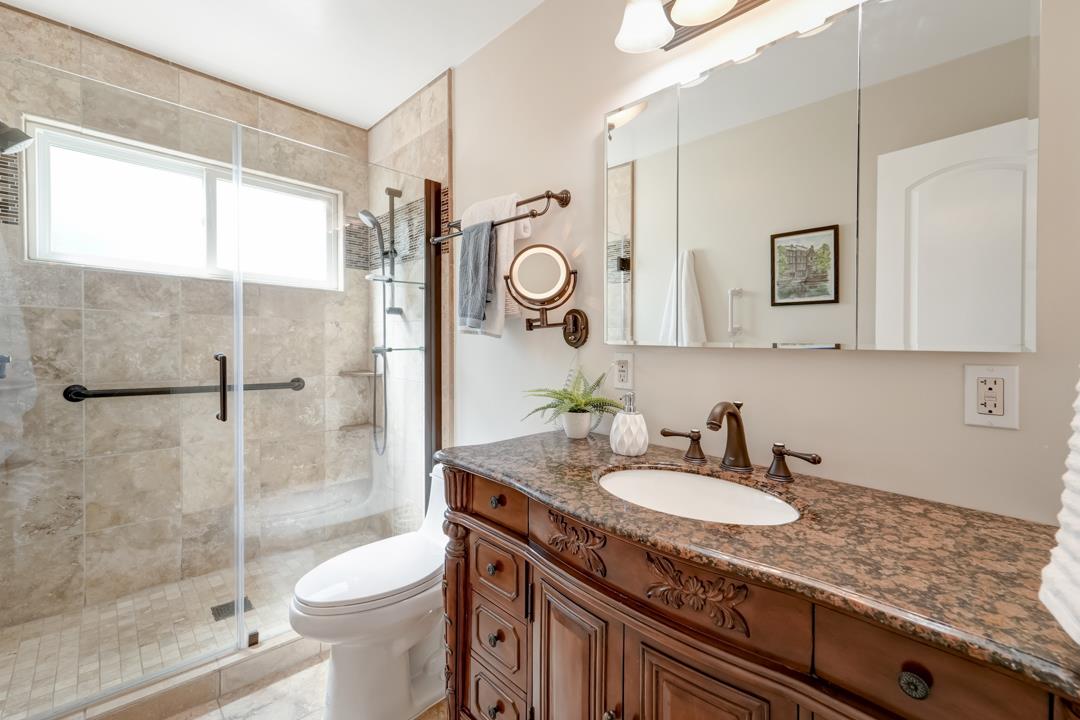 637 Laird Lane Lafayette, CA 94549 - Photo 27 of 44 a bathroom with a granite countertop sink toilet mirror and shower