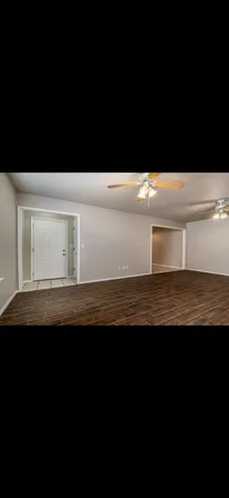 a view of room with wooden floor