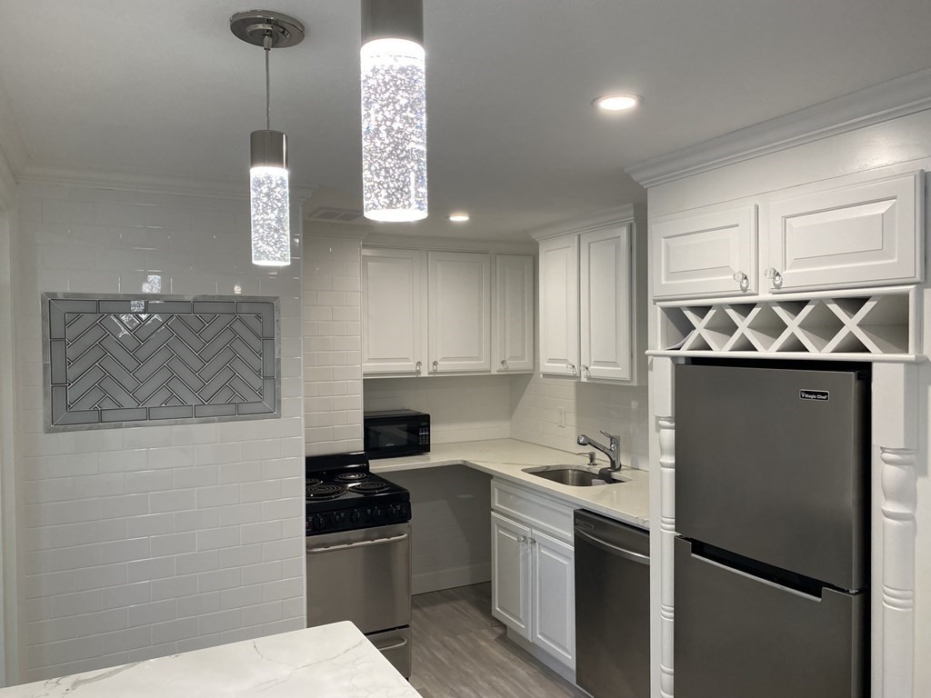 210 Hillside Avenue, Unit 37 Needham, MA 02494 - Photo 1 of 14 a kitchen with stainless steel appliances granite countertop a refrigerator a stove a sink and a microwave