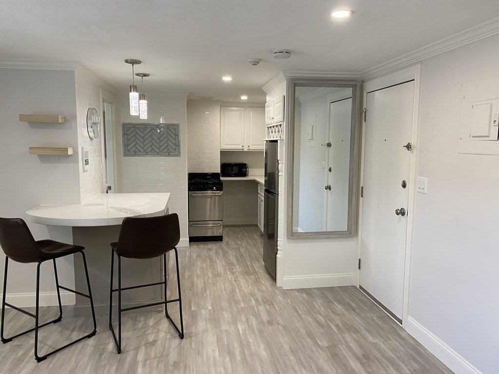 210 Hillside Avenue, Unit 37 Needham, MA 02494 - Photo 4 of 14 a large kitchen with a table and chairs
