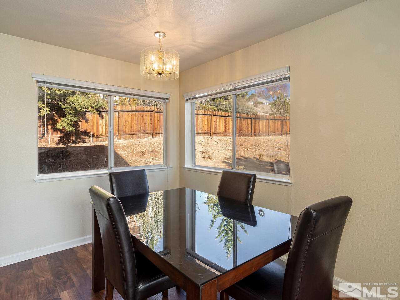 821 University Ridge Drive Reno, NV 89512 - Photo 12 of 28 a view of a dining room with furniture large window and outside view