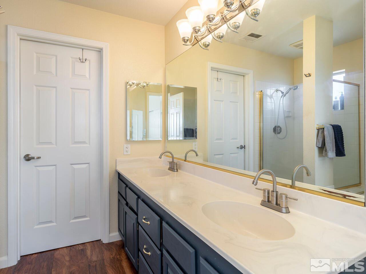 821 University Ridge Drive Reno, NV 89512 - Photo 19 of 28 a bathroom with a double vanity sink and a mirror