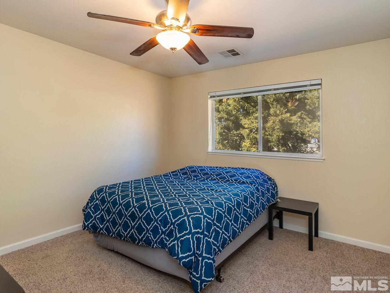 821 University Ridge Drive Reno, NV 89512 - Photo 21 of 28 a bedroom with a bed and a window
