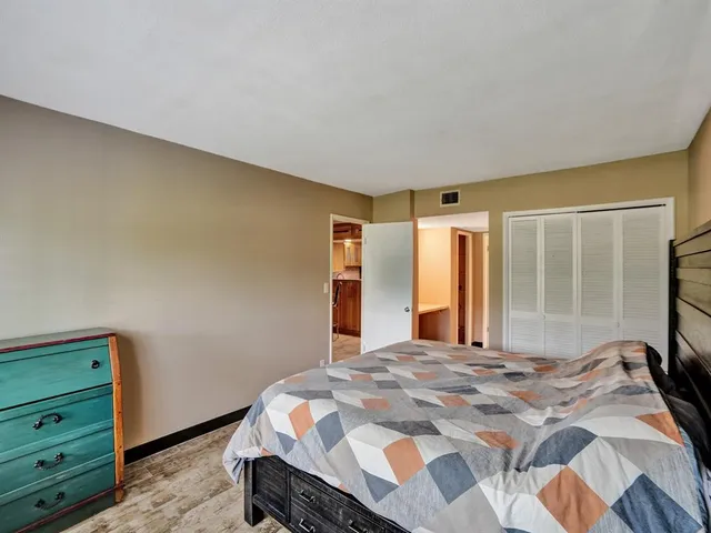 a bedroom with a large bed and a window