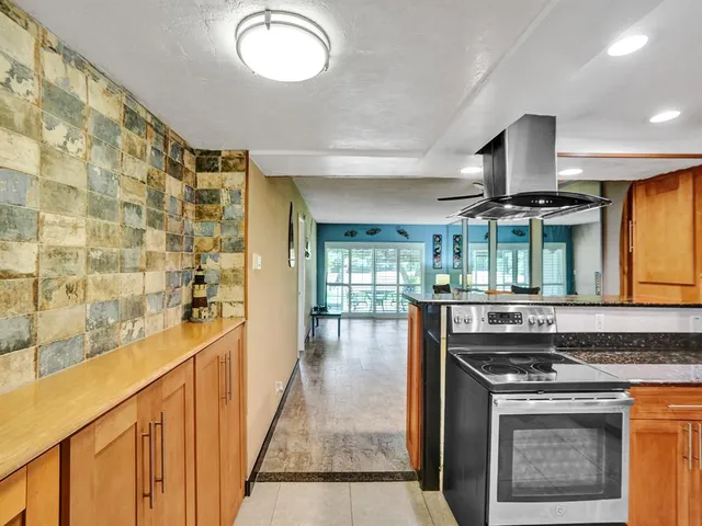a kitchen with a stove and a sink