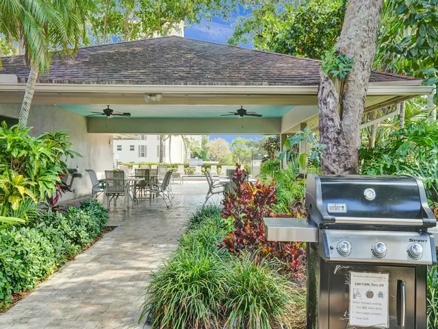 a view of a field with trees in the background