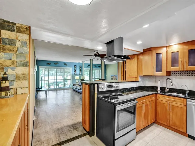 a kitchen with stainless steel appliances granite countertop a stove and a sink