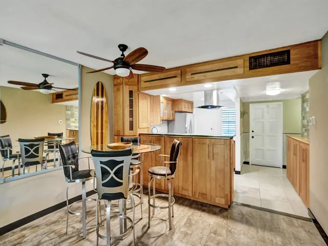 a dining room with furniture and a chandelier