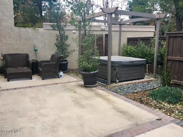 a view of backyard with outdoor seating and plants