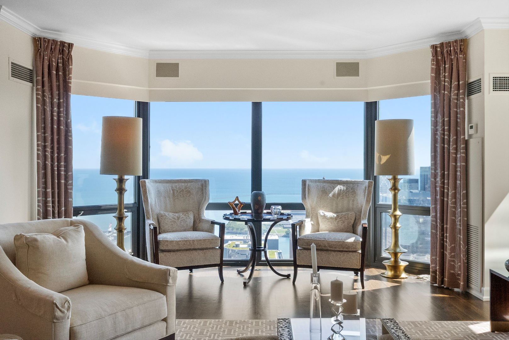 100 East Huron Street, Unit 4503 Chicago, IL 60611 - Photo 11 of 50 a living room with couches chairs and a coffee table with wooden floor