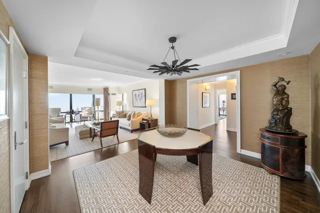 a living room with furniture a table and kitchen view