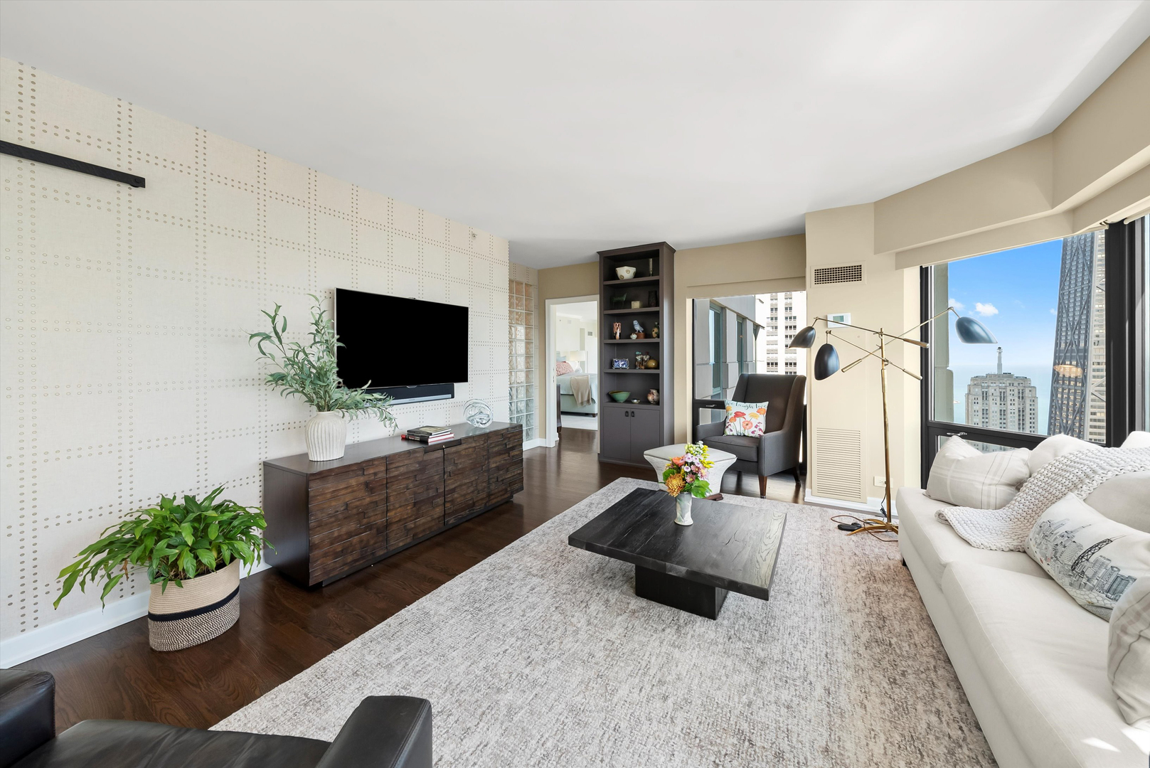 100 East Huron Street, Unit 4503 Chicago, IL 60611 - Photo 22 of 50 a living room with furniture and a flat screen tv