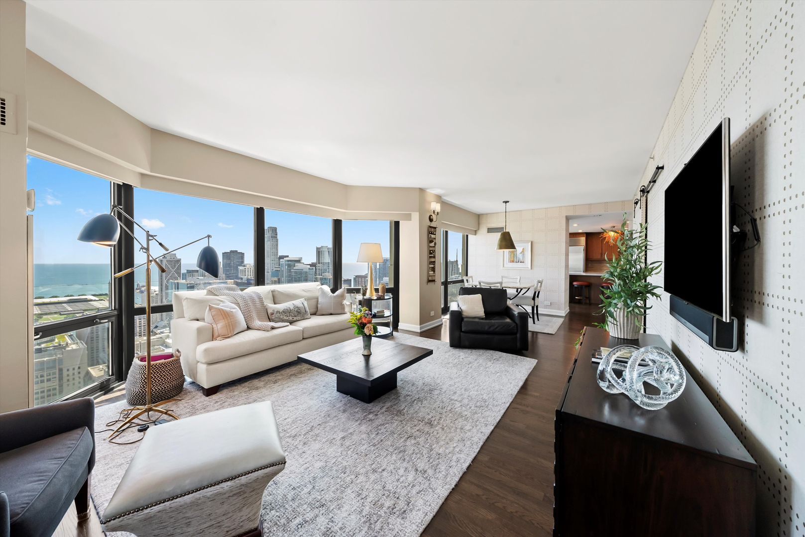 100 East Huron Street, Unit 4503 Chicago, IL 60611 - Photo 23 of 50 a living room with furniture fireplace and a flat screen tv
