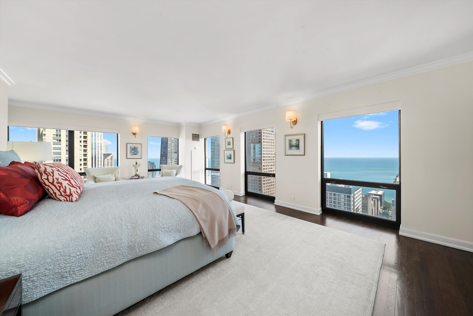 100 East Huron Street, Unit 4503 Chicago, IL 60611 - Photo 29 of 50 a spacious bedroom with a bed a dresser and next to a window