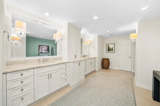 a spacious bathroom with a double vanity sink and a mirror