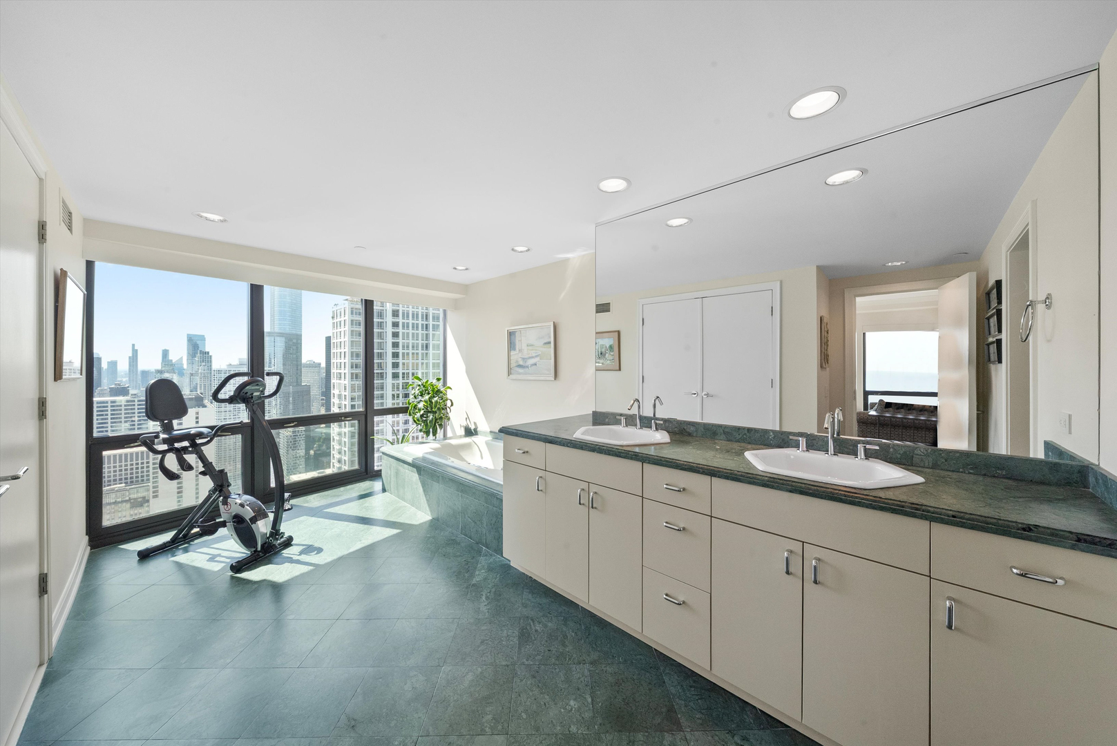 100 East Huron Street, Unit 4503 Chicago, IL 60611 - Photo 37 of 50 a view of a kitchen with dining table stainless steel appliances and a large window