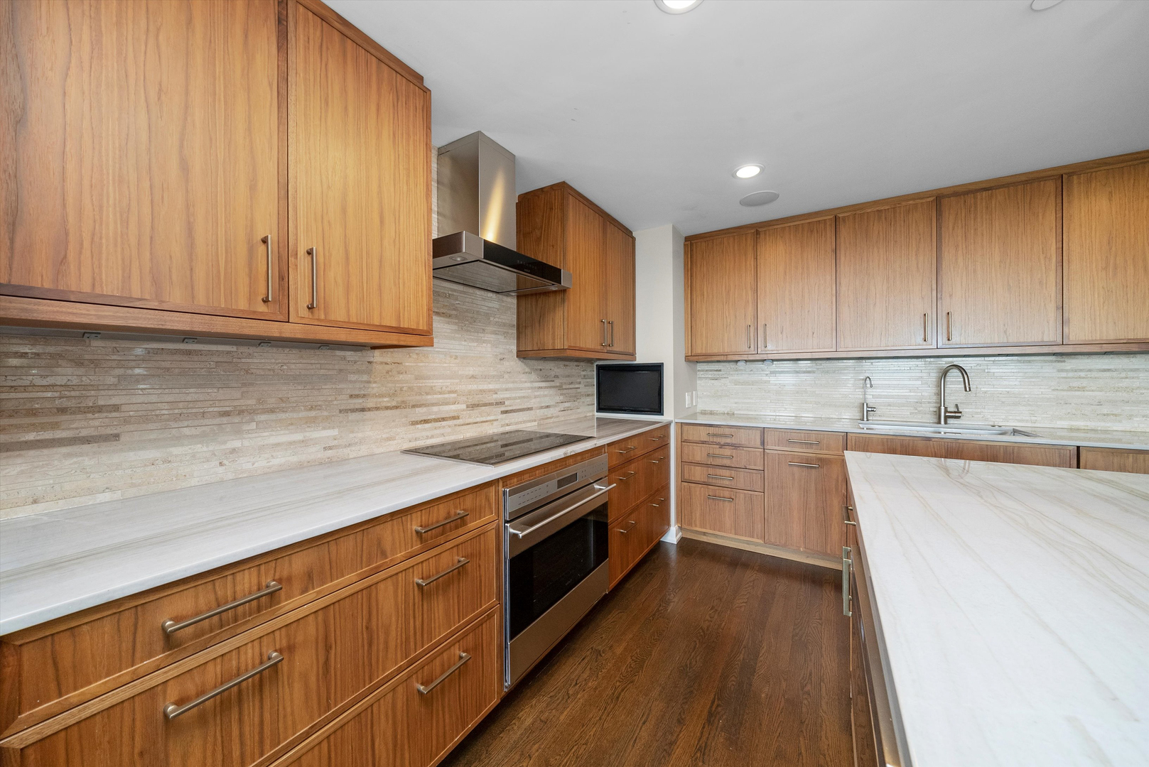 100 East Huron Street, Unit 4503 Chicago, IL 60611 - Photo 4 of 50 a kitchen with granite countertop wooden cabinets stainless steel appliances and a counter space