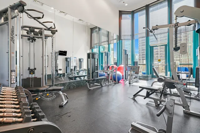 a living room with lots of gym equipment
