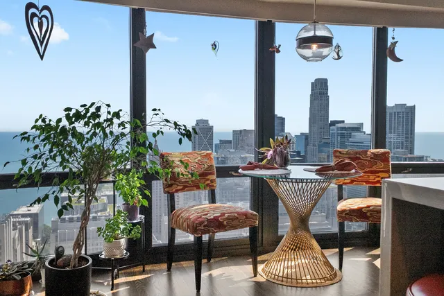 a living room with furniture a rug and a floor to ceiling window