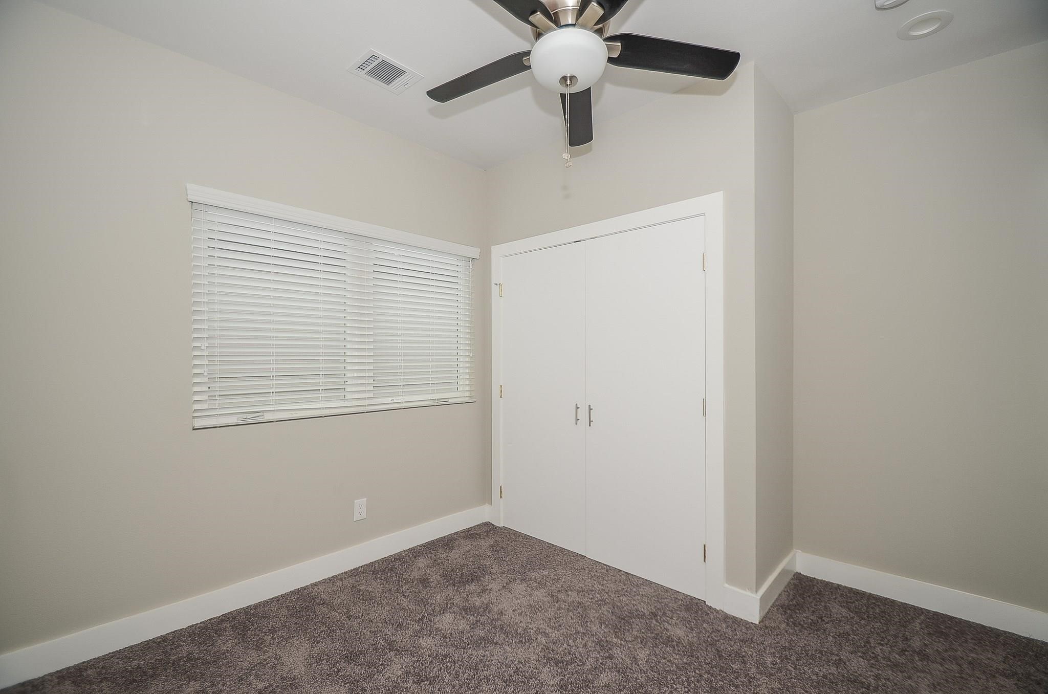 3249 Dixie Drive, Unit B Houston, TX 77021 - Photo 3 of 8 an empty room with a window and a fan