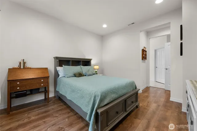 a bedroom with a bed and a car parked