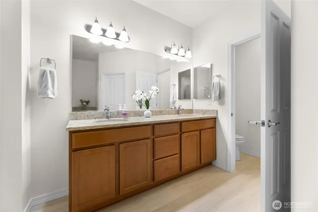 a bathroom with a double vanity sink and a mirror