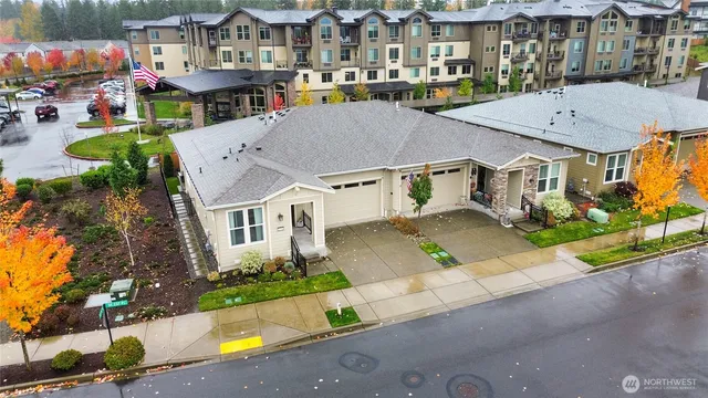 an aerial view of multiple houses with a street
