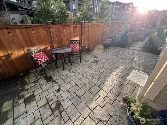 a backyard of a house with table and chairs