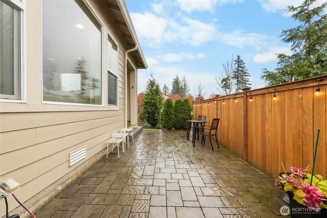 a view of a patio with a table and chairs and potted plants