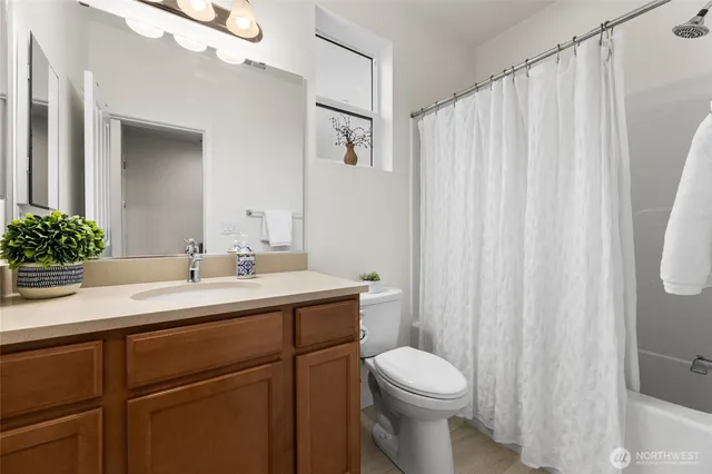 a bathroom with a toilet a sink and a mirror