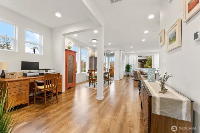 a living room with furniture a wooden floor and a flat screen tv